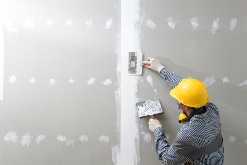 man repairing drywall